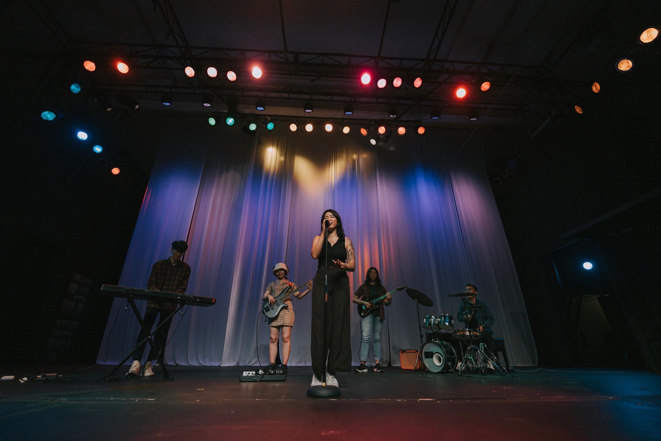 Church worship band performing under stage lighting